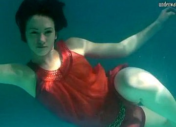 Mermaid Dressed In Red Rusalka Swimming In The Pool